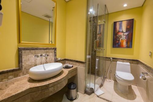 a bathroom with a sink and a toilet at Boudl Al Woroud بودل الورود in Riyadh