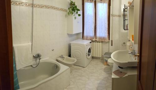 a bathroom with a tub and a toilet and a sink at La Collina in Riccò del Golfo di Spezia
