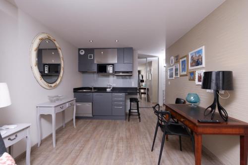 a kitchen and dining room with a table and a desk at At home in lyon in Lyon