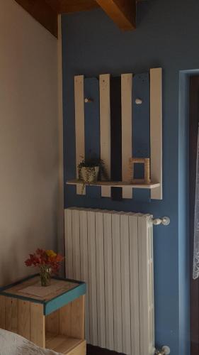 a room with a radiator and a shelf on the wall at B&B Amici del Colle in San Colombano al Lambro
