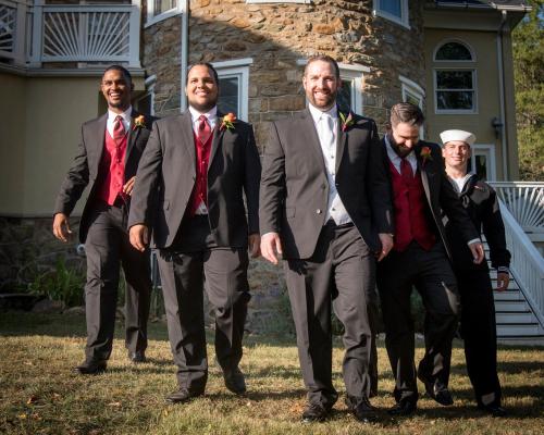 a group of men in suits standing in front of a house at Stone Manor Boutique Inn in Britain