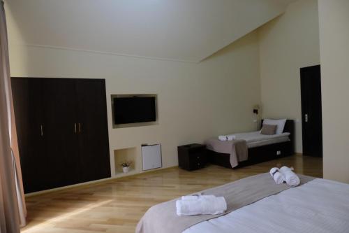a hotel room with two beds and a television at S&L Boutique Hotel in Tbilisi City