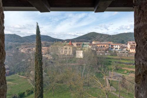 a view of a town from a window of a building at Hotel Cal Sastre in Santa Pau