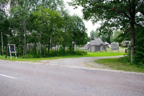an empty road next to a farm with trees at Kase Holiday Center in Paiküla