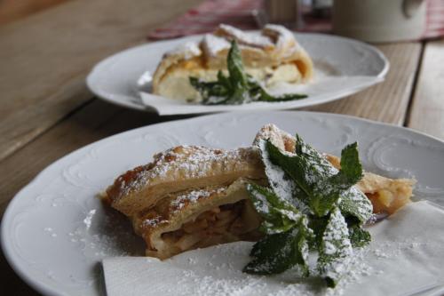 two plates of food on a wooden table at Stadtalm Naturfreundehaus in Salzburg