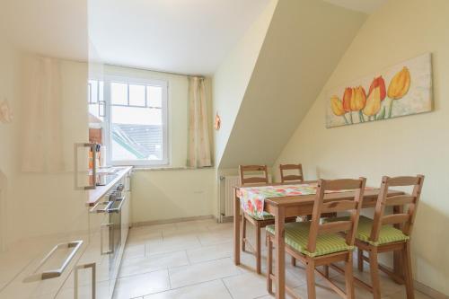 a kitchen with a table and chairs in a room at Bauernhof Marquardt in Fehmarn