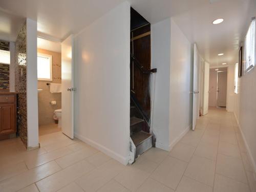 a hallway with a door to a bathroom with a toilet at Shore Beach Houses - 111 Lincoln Ave in Seaside Heights