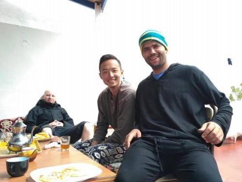 a group of people sitting around a table at White And Blue in Essaouira