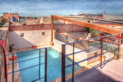 - un balcon avec une piscine dans un bâtiment dans l'établissement Riad Carina, à Marrakech