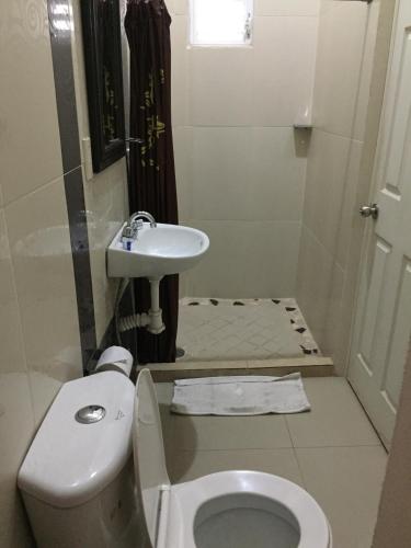 a bathroom with a toilet and a sink at Casa del Parque Vallarta in Puerto Vallarta