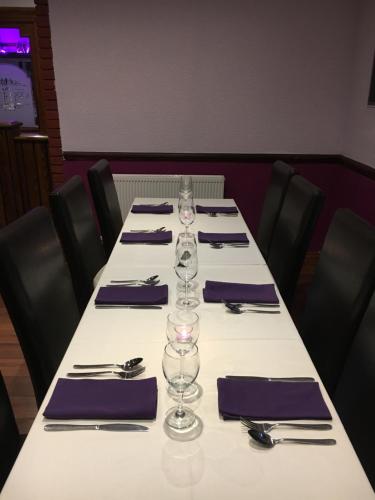 a long table with wine glasses and napkins on it at Croxdale Inn in Durham