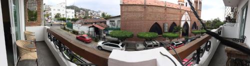 a balcony with a view of a city with cars at Casa del Parque Vallarta in Puerto Vallarta