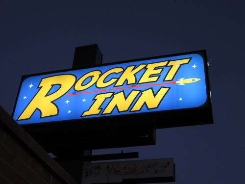 a sign for a pokemon tv on top of a building at Rocket Inn in Truth or Consequences