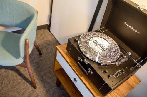 a chair next to a table with a fan on it at The Oxbow Hotel in Eau Claire