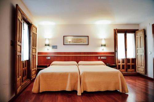 Cama o camas de una habitación en Hotel Santa Isabel