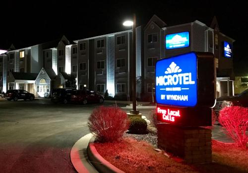 a hotel sign in front of a building at night at Microtel Inn and Suites Elkhart in Elkhart