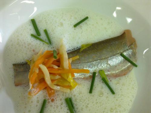 a white plate of food with vegetables on it at Wohlfühlhotel Goiserer Mühle in Bad Goisern