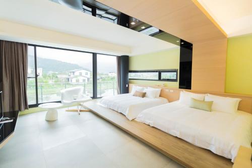 a bedroom with two beds and a large window at sunlight mound in Yuanshan