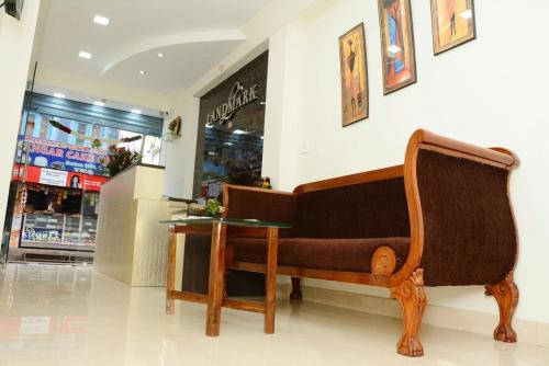 a bench and a table in front of a store at Hotel Landmark in Ooty