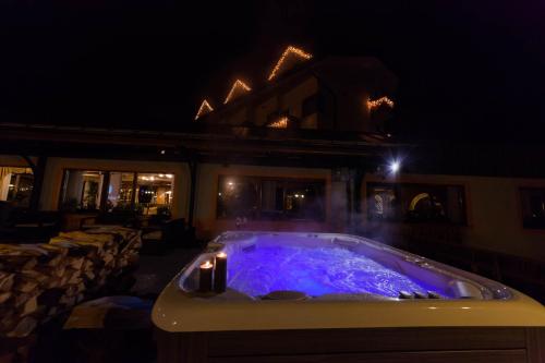 a hot tub at a restaurant at night at Hotel Europa in San Martino di Castrozza