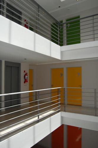 an empty gym with yellow and orange doors at America Del Sur Hostel Buenos Aires in Buenos Aires