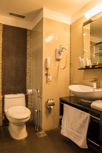 a bathroom with a toilet and a sink at The Red Maple Mashal in Indore