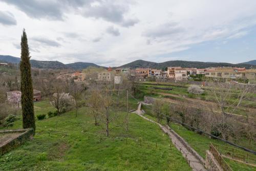a view of a park with a town in the background at Hotel Cal Sastre in Santa Pau