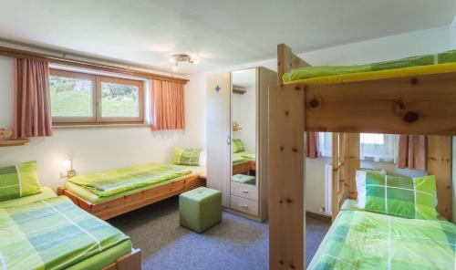 a bedroom with two bunk beds and a mirror at Haus Michael in Tux