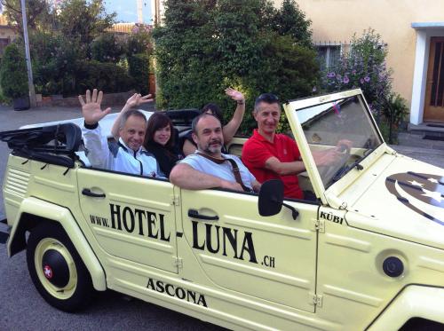 a group of people riding in the back of a truck at Hotel Luna Garni in Ascona