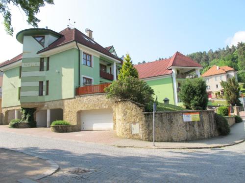 a large house with a garage on a street at Penzion Stella in Luhačovice