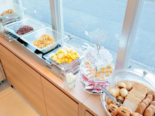 a buffet with different types of food on a counter at Candeo Hotels Handa in Handa