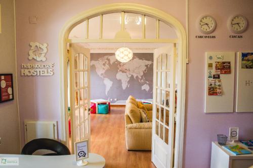 um quarto com uma porta que leva a uma sala de estar em Help Yourself Hostels - Carcavelos Coast em Carcavelos