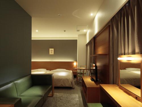 Gulta vai gultas numurā naktsmītnē Candeo Hotels Chino