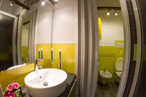 a bathroom with a sink and a toilet and candles at A Casa Di Agata in Pellezzano