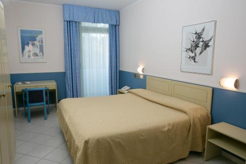 a hotel room with a bed and a window at Hotel Salsello in Bisceglie