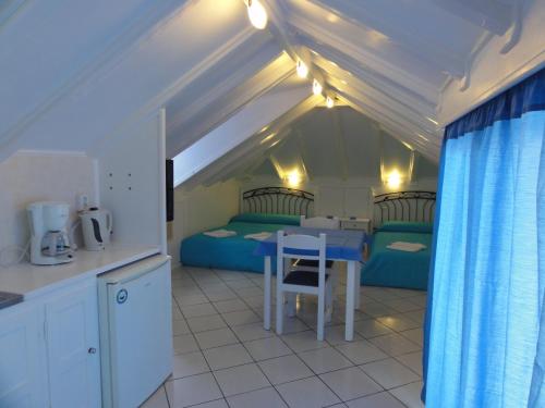 a kitchen with two beds and a table in a room at Botsis Guest House in Hydra