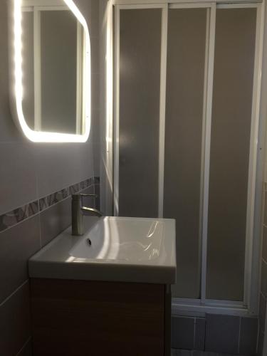 a bathroom with a sink and a mirror at Résidence Natura in Ax-les-Thermes