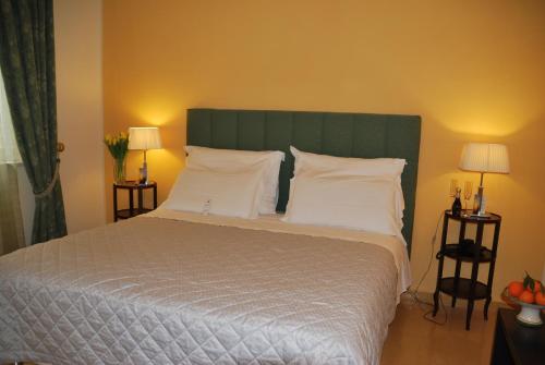 a bedroom with a large bed with white pillows at Domus Mariae Benessere in Siracusa
