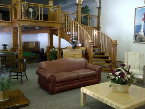 a living room with a couch and a staircase at Three Valley Lake Chateau in Revelstoke