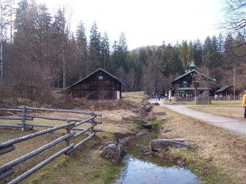 a fence and a pond in front of some buildings at Pension Arbersonne in Bayerisch Eisenstein