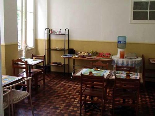 a dining room with tables and chairs in a room at Palace Hotel in Curitiba