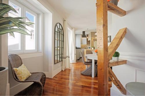 a living room with a staircase and a table and chairs at Duque-Chiado Downtown in Lisbon