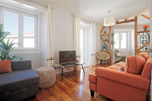 a living room with two couches and a tv at Duque-Chiado Downtown in Lisbon