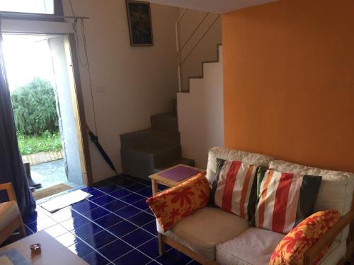 a living room with a couch and a staircase at Villa Li Schisani in Sorrento