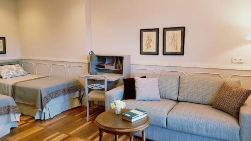 a living room with a couch and a table at Hotel Alcazar Irun in Irún