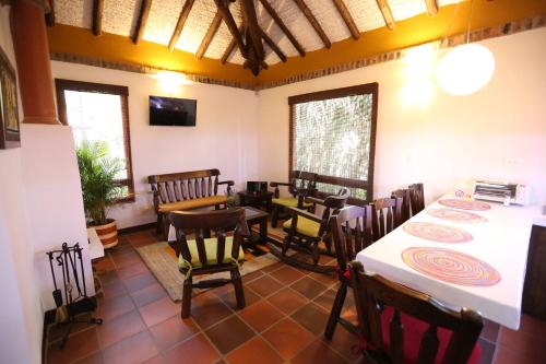 a dining room with a table and some chairs at La Estancia de la Pradera Cabana Fiba in Nobsa