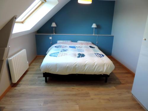 Campénéac的住宿－薩福克爾度假屋，一间卧室配有一张蓝色墙壁的床