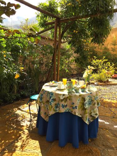 a table with a blue and white table cloth at Hotel Casa Terra in Villa de Leyva