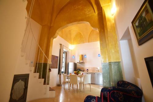 a kitchen and dining room with a table and chairs at Palazzo Salapolis - Luxury Apartments in Gallipoli