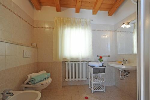 a bathroom with a toilet and a sink at Appartamento Ai Ruck in Limone sul Garda